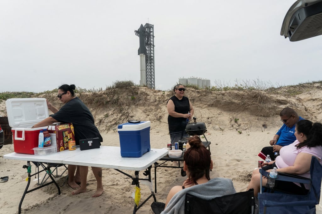 People picnic on the beach park near the SpaceX Starship on its Boca Chica launch pad near Brownsville, Texas on Sunday. Photo: Reuters