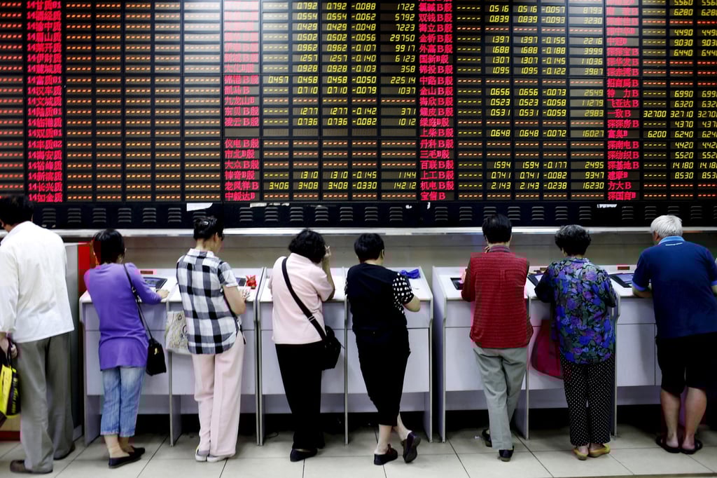 Investors look at computer screens showing stock information at a brokerage house in Shanghai, China. Photo: Reuters Investors look at computer screens showing stock information at a brokerage house in Shanghai, China. Photo: Reuters