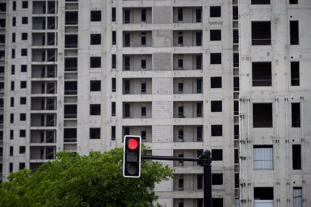 A traffic light is seen near a construction site of residential buildings in Shanghai, China PHOTO: REUTERS