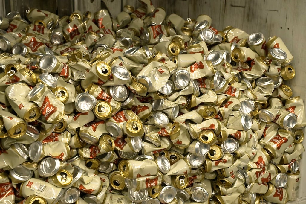 Cans of Miller High Life beer in a container after being crushed at the Westlandia plant in Ypres, Belgium. Photo: AP Cans of Miller High Life beer in a container after being crushed at the Westlandia plant in Ypres, Belgium. Photo: AP