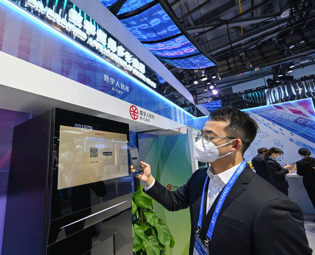 A staff member shows the payment with China’s digital yuan, or the e-CNY. Photo: Xinhua A staff member shows the payment with China’s digital yuan, or the e-CNY. Photo: Xinhua