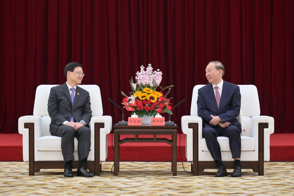 John Lee (left) met party chief Huang Kunming in Guangzhou. Photo: Handout John Lee (left) met party chief Huang Kunming in Guangzhou. Photo: Handout
