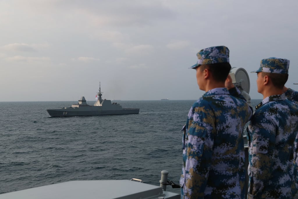 Chinese sailors salute as a vessel of Singapore’s navy passes their ship during their last joint drills held in 2021. Photo: Xinhua