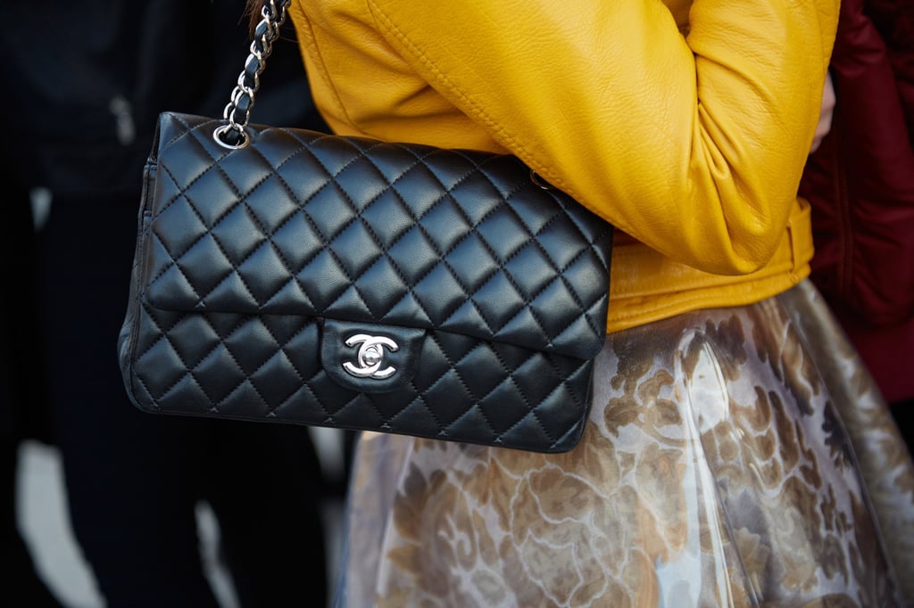 A woman poses with black leather Chanel bag and yellow jacket in February 2016, in Milan. Photo: Shutterstock A woman poses with black leather Chanel bag and yellow jacket in February 2016, in Milan. Photo: Shutterstock