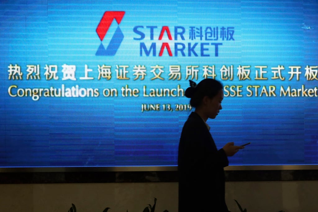A woman walks past a display promoting the Star Market, a stock market for hi-tech Chinese companies. Photo: AP Photo A woman walks past a display promoting the Star Market, a stock market for hi-tech Chinese companies. Photo: AP Photo