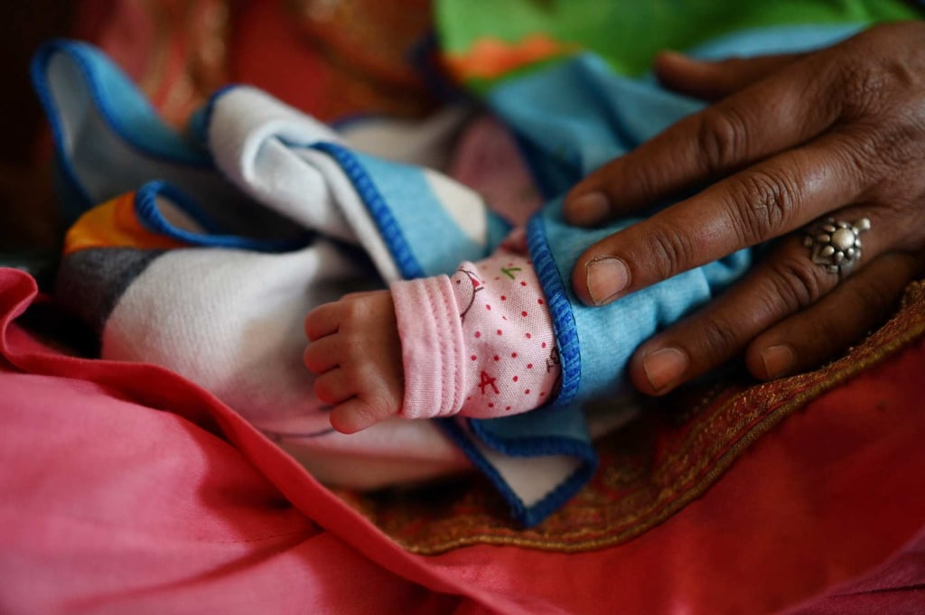 A woman holds on her lap her grandchild at a hospital in Dehra, in Kangra district of Himachal Pradesh, on April 24. More than two-thirds of all Indians are between the ages of 15 and 59, so the country’s ratio of children and retirees to working-age adults is low. Photo: AFP A woman holds on her lap her grandchild at a hospital in Dehra, in Kangra district of Himachal Pradesh, on April 24. More than two-thirds of all Indians are between the ages of 15 and 59, so the country’s ratio of children and retirees to working-age adults is low. Photo: AFP