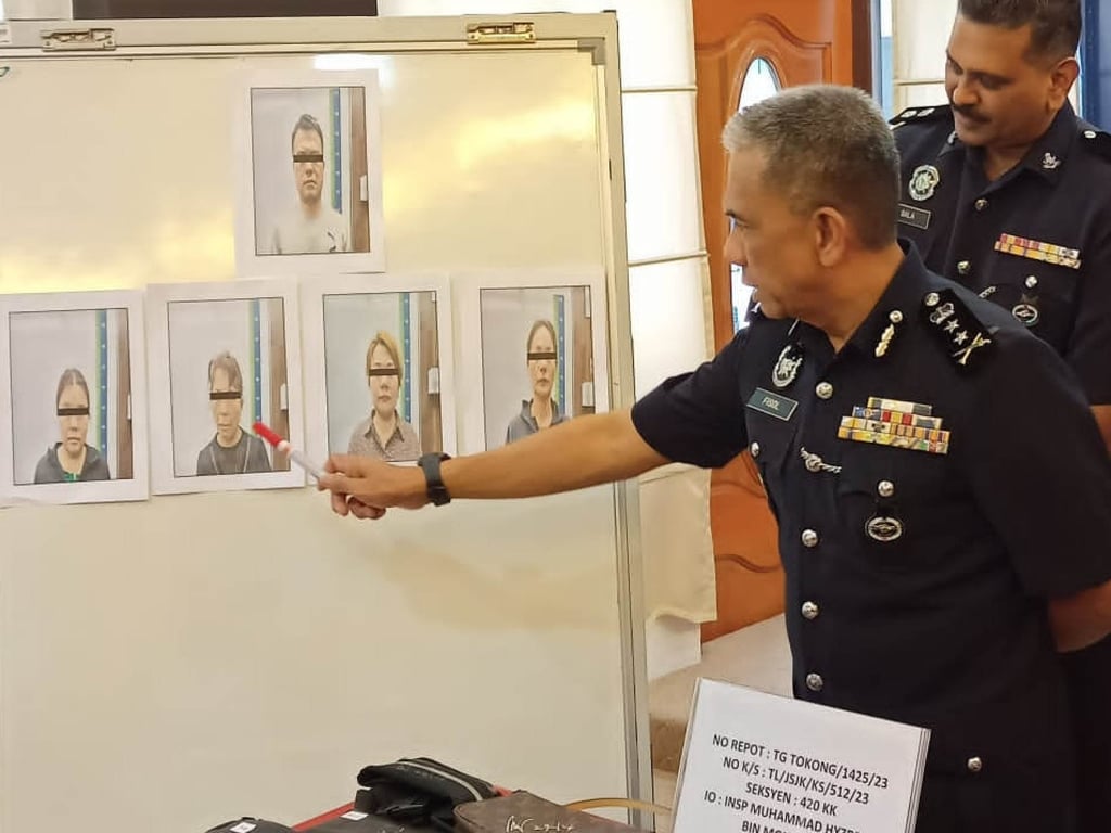 Fisol Salleh points to photos of the suspects who were arrested at Kuala Lumpur International Airport last week. Photo: Facebook/PolisPulauPinang