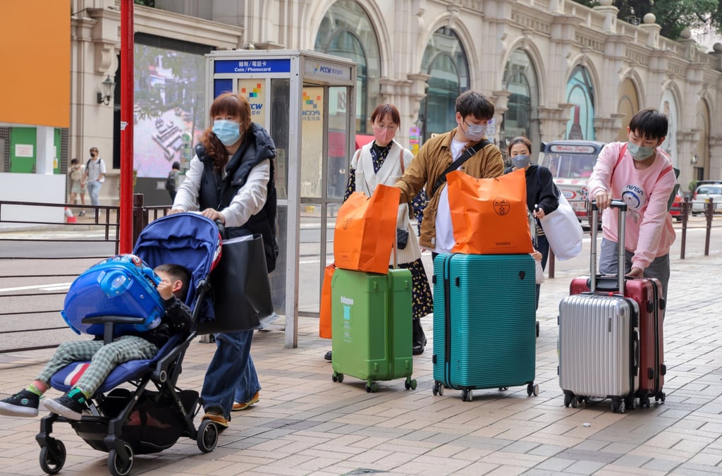 Tourists walk along Canton Road in Tsim Sha Tsui on the first day of full border reopening as all checkpoints between Hong Kong and mainland China reopen, free from Covid-19 restrictions, on February 6, 2023. 06FEB23 SCMP / Jelly Tse