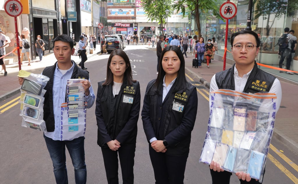 Shun Po-chun (second from left), chief inspector of the Wan Chai district, with officers showing some of the items recovered in the latest operation. Photo: Jelly Tse Shun Po-chun (second from left), chief inspector of the Wan Chai district, with officers showing some of the items recovered in the latest operation. Photo: Jelly Tse