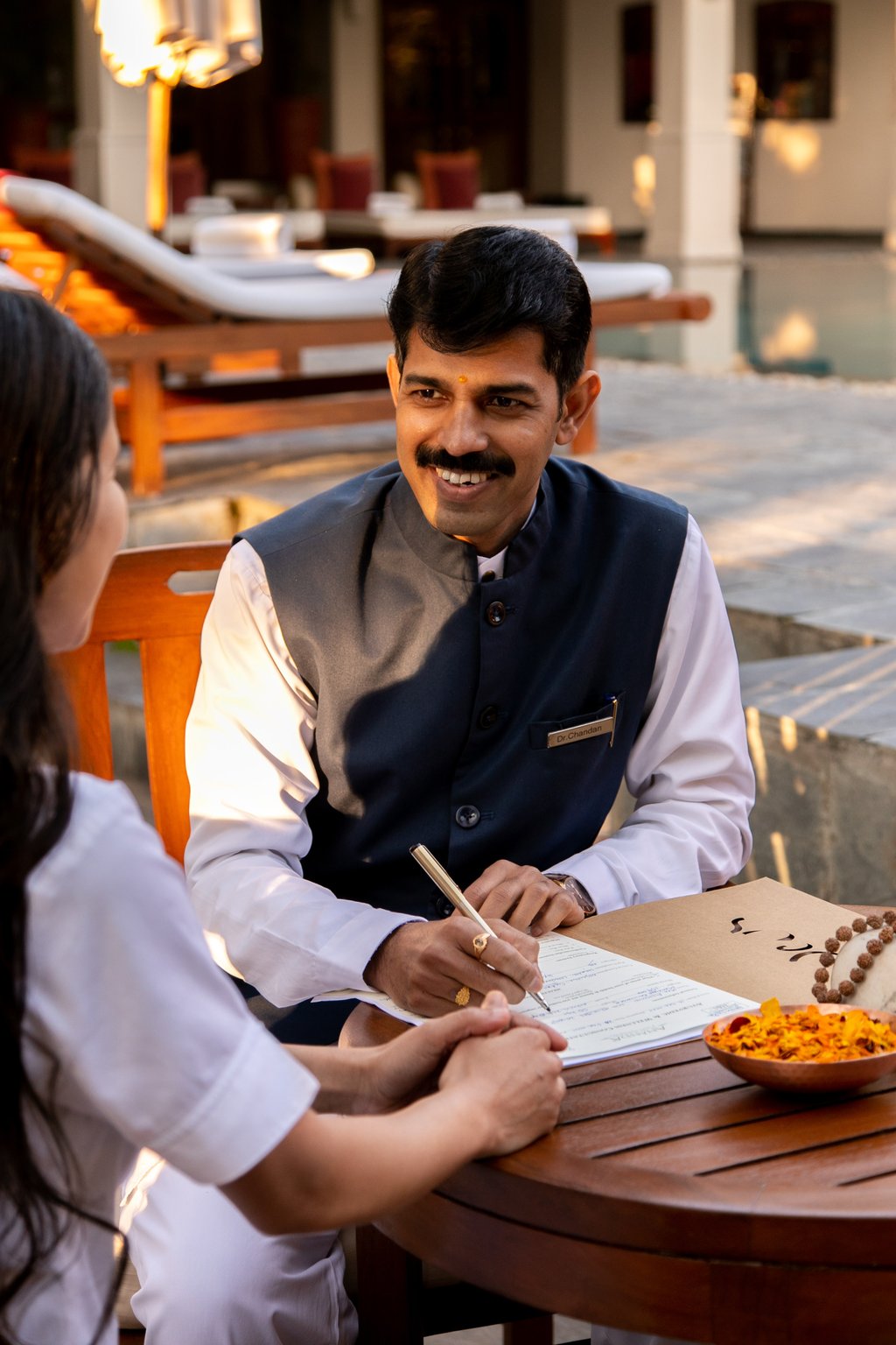 Chandan Malatkar Chandramohan consults with a guest at the Ananda in the Himalayas resort. Photo: Ananda in the Himalayas