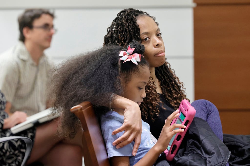 Philana Holmes and her daughter listen to the final witness in their case at the Broward County Courthouse in Fort Lauderdale, Florida, on Wednesday. Photo: TNS