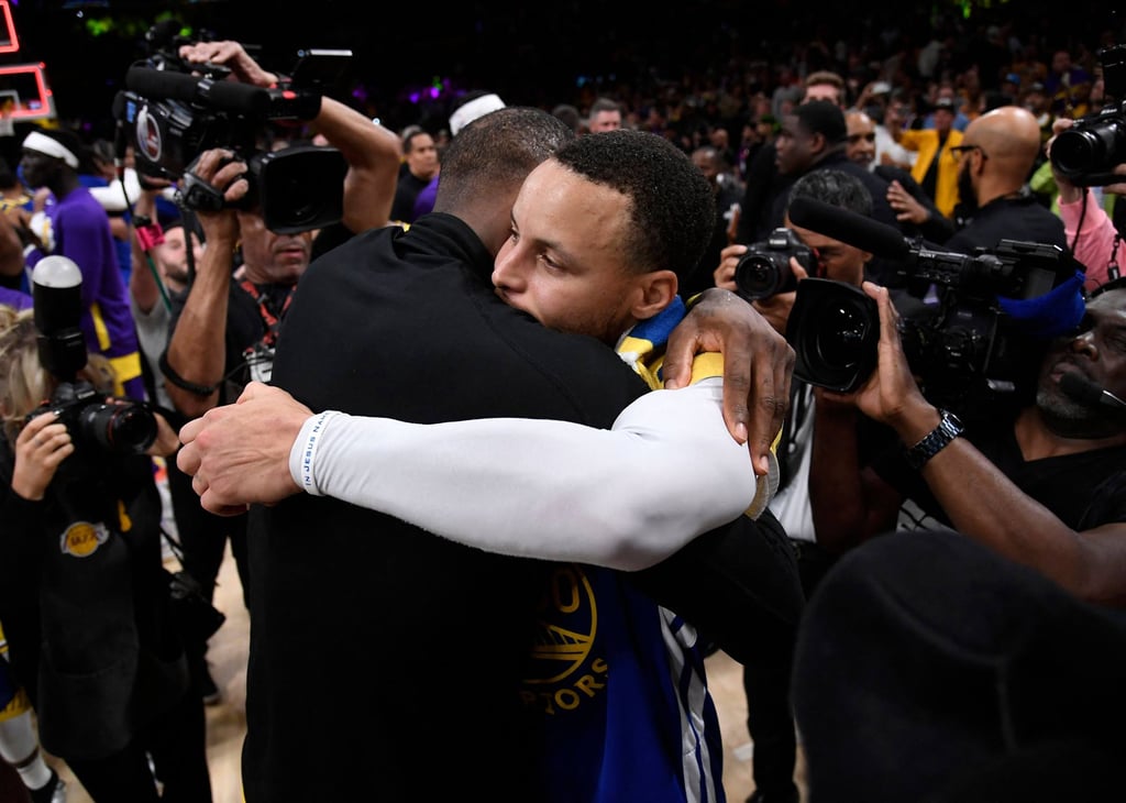 Stephen Curry of the Golden State Warriors hugs LeBron James of the Los Angeles Lakers after the game. Photo: AFP