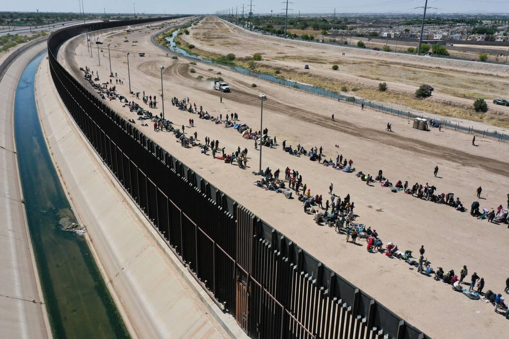 An aerial image shows migrants waiting along the border wall to surrender to US Customs and Border Protection agents in El Paso, Texas, on Thursday. Photo: TNS