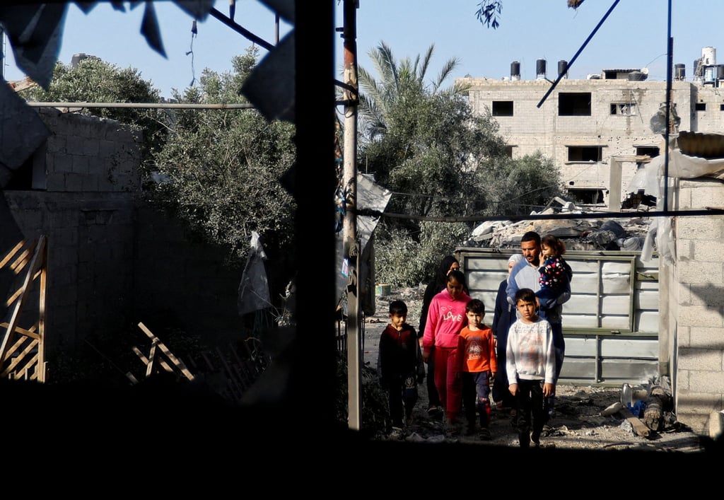 People look at a building, which was destroyed in an Israeli strike during Israel-Gaza fighting, after a ceasefire was agreed between Palestinian factions and Israel, in Deir Al-Balah, central Gaza Strip on Sunday. Photo: Reuters