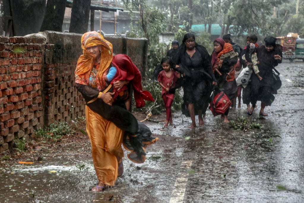 People move from their homes to the nearest cyclone shelter at Shah Porir Dwip during the landfall of Cyclone Mocha in Teknaf, Bangladesh, on Sunday. Photo: Reuters