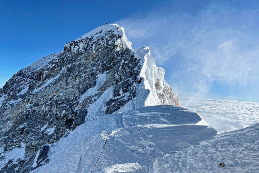 Mountaineers climb the Hillary Step during their ascent of the south face to the summit Mount Everest, in Nepal. Photo: TNS Mountaineers climb the Hillary Step during their ascent of the south face to the summit Mount Everest, in Nepal. Photo: TNS