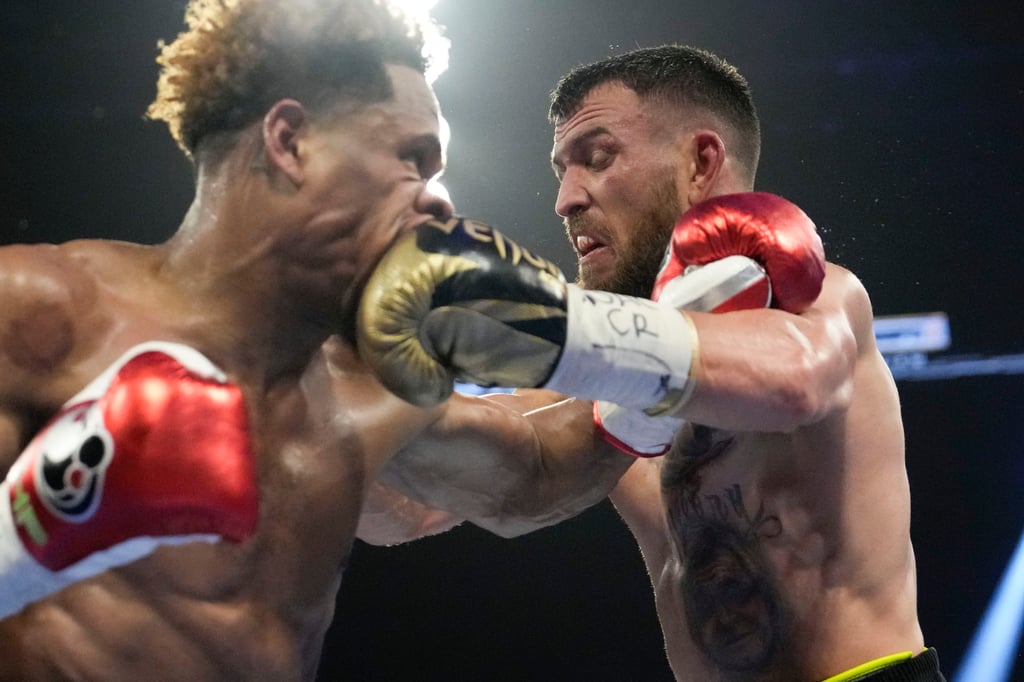 Devin Haney and Vasiliy Lomachenko exchange punches. Photo: AP Devin Haney and Vasiliy Lomachenko exchange punches. Photo: AP