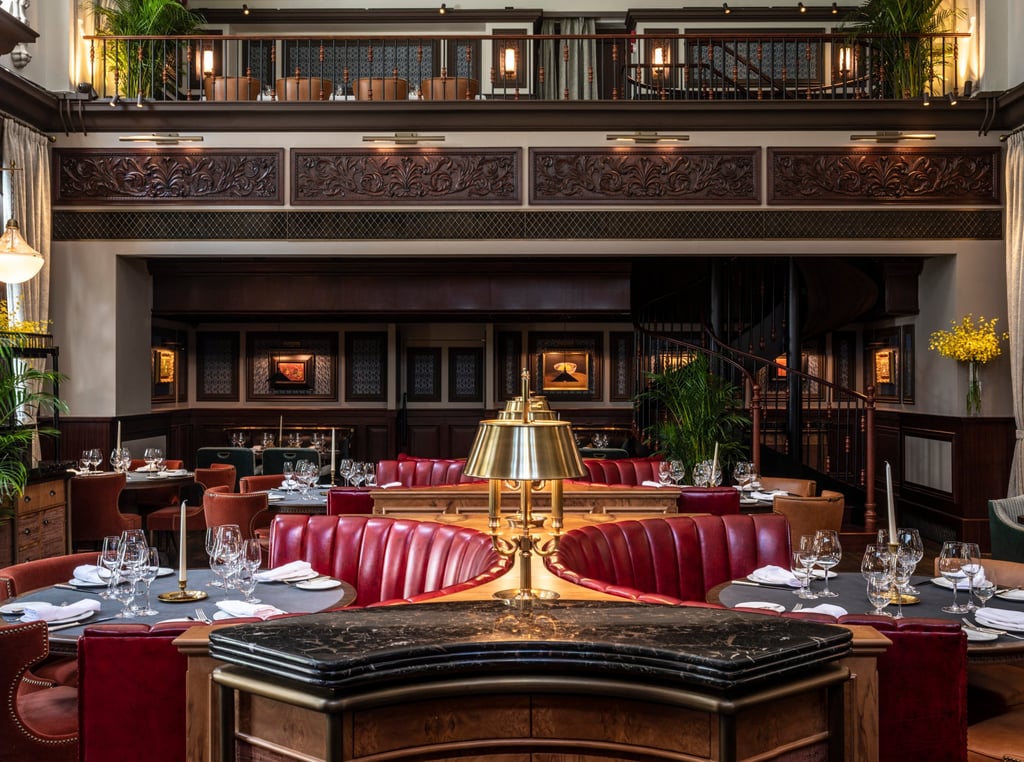 Materials used by Joyce Wang Design for The Magistracy have a stately presence: burred woods, marble, leather in a burgundy tone and brass table lamps. Photo: Handout