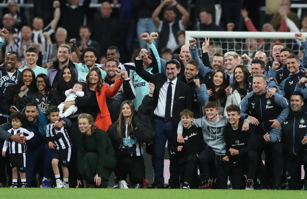 Newcastle United chairman Yasir Al-Rumayyan, directors Amanda Stavely, Mehrdad Ghodoussi and Jamie Reuben pose with the players, coaching staff and their families during a lap of appreciation after qualifying for the Champions League. Photo: Reuters