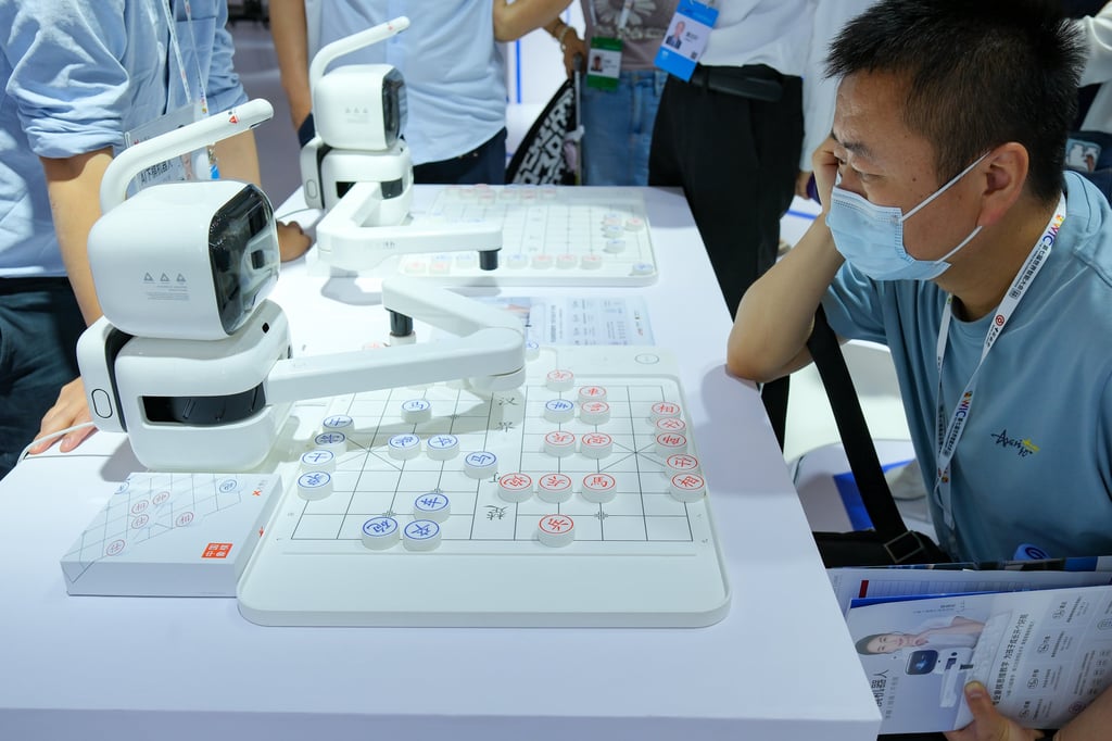 A visitor plays Chinese chess with an artificial intelligence robot at an exhibition during the seventh World Intelligence Congress in Tianjin on May 18, 2023. Photo: Xinhua
