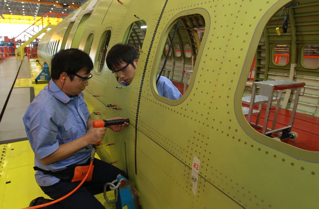 Technicians install rivets on fuselage of C919 airliner in the assembly base of the Commercial Aircraft Corporation of China in Shanghai in September 2014. Photo: Xinhua Technicians install rivets on fuselage of C919 airliner in the assembly base of the Commercial Aircraft Corporation of China in Shanghai in September 2014. Photo: Xinhua