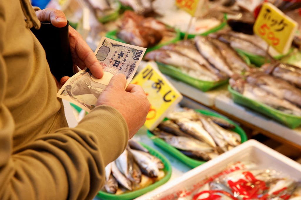A man buys fish at a market in Tokyo. Sardine, mackerel, saury and Japanese flying squid catches all declined last year. Photo: Reuters A man buys fish at a market in Tokyo. Sardine, mackerel, saury and Japanese flying squid catches all declined last year. Photo: Reuters