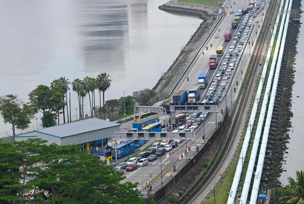 Vehicles coming from Johor, Malaysia, form a queue as they approach the immigration checkpoint to enter Singapore. Photo: AFP