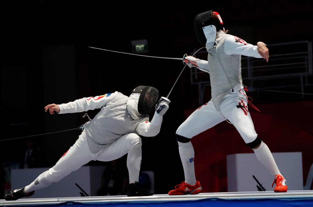 Hong Kong’s Nicholas Choi (right) battles with China’s Huang Mengkai in the men’s foil individual final at the 2018 Asian Games in Jakarta. Photo: Reuters Hong Kong’s Nicholas Choi (right) battles with China’s Huang Mengkai in the men’s foil individual final at the 2018 Asian Games in Jakarta. Photo: Reuters