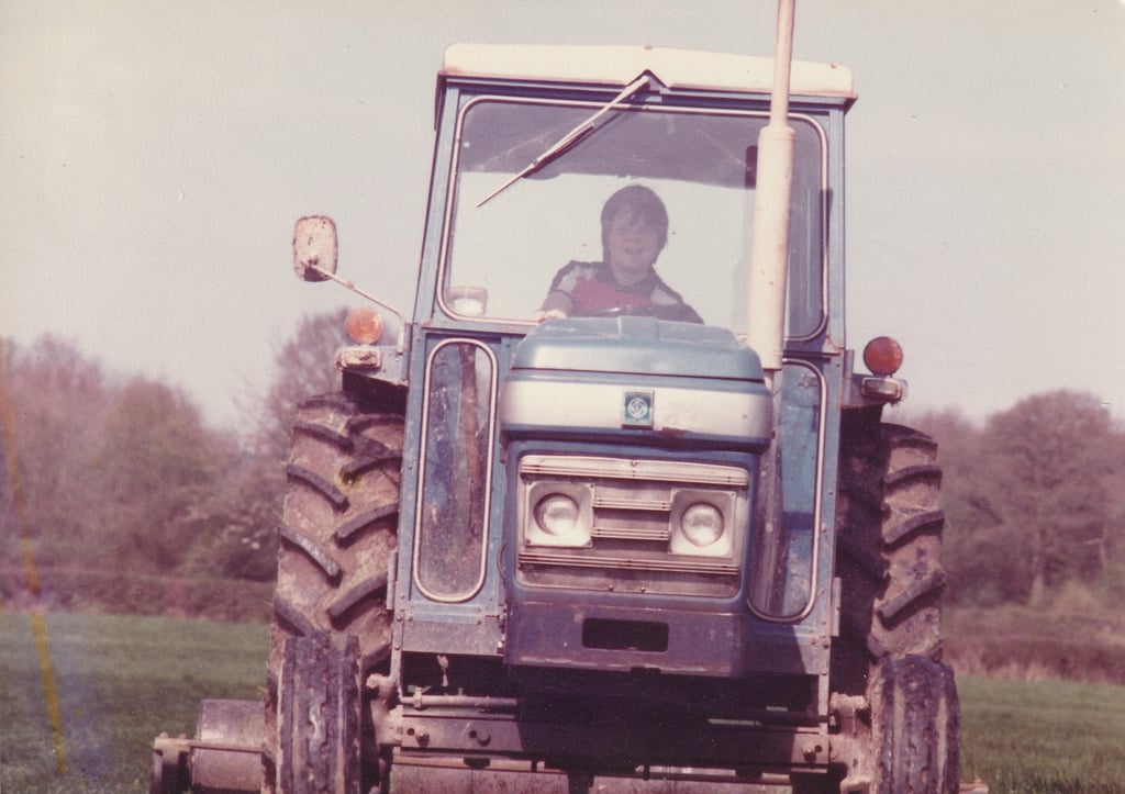 A young Barrow drives a tractor on the family farm in Kent, southeast England. Photo: Richard Barrow