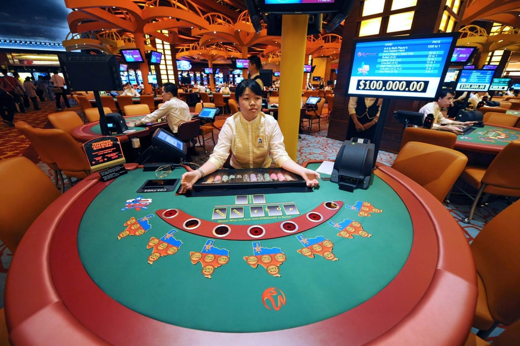 A dealer stands by a table in Singapore’s first casino, in Resorts World Sentosa, in 2010. Photo: AFP A dealer stands by a table in Singapore’s first casino, in Resorts World Sentosa, in 2010. Photo: AFP