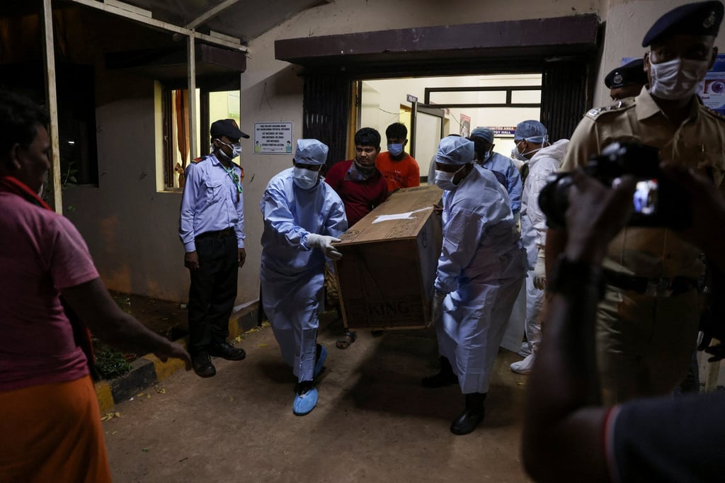 Healthcare workers help a family to load a makeshift coffin of a relative into an ambulance after a train collision in Balasore, at a hospital in Bhubaneswar in the eastern state of Odisha, India on Sunday. Photo: Reuters
