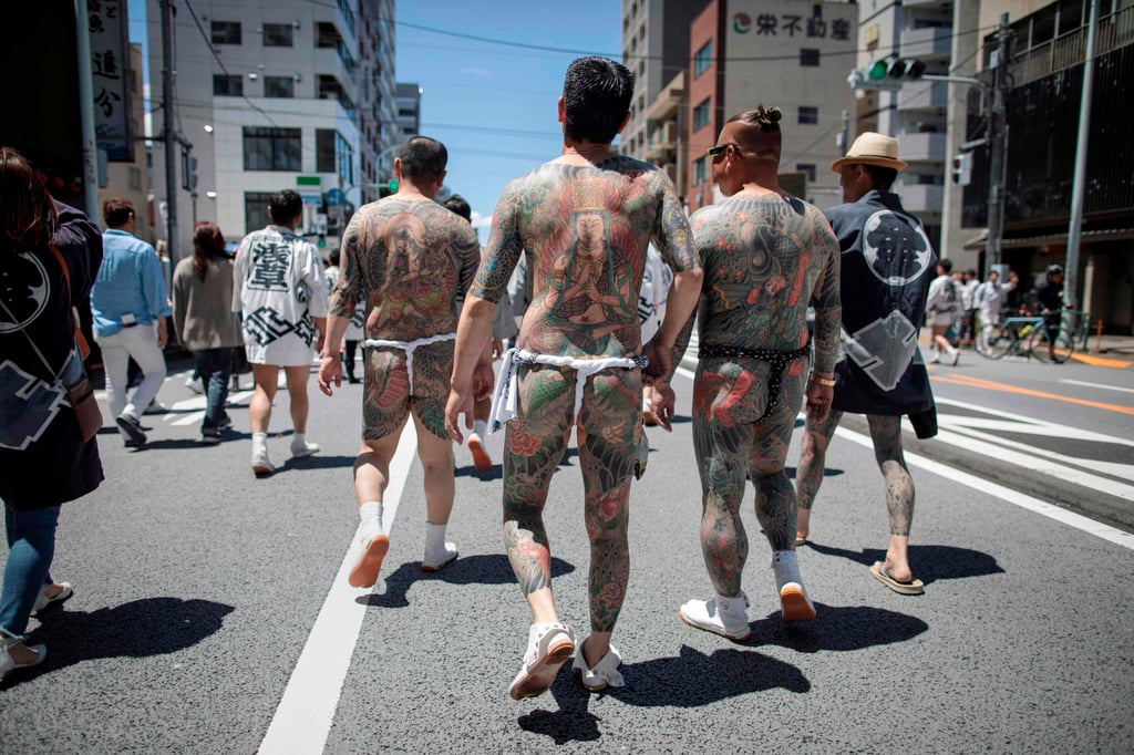 Participants with traditional Japanese tattoos (Irezumi), related to the yakuza, walk through the Asakusa district during the annual Sanja Matsuri festival in Tokyo in May 2018. Photo: AFP Participants with traditional Japanese tattoos (Irezumi), related to the yakuza, walk through the Asakusa district during the annual Sanja Matsuri festival in Tokyo in May 2018. Photo: AFP
