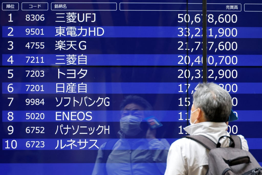 A man looks at an electric monitor displaying a stock quotation board outside a bank in Tokyo. Japan’s banks are also sitting on vast piles of surplus liquidity at present. Photo: Reuters A man looks at an electric monitor displaying a stock quotation board outside a bank in Tokyo. Japan’s banks are also sitting on vast piles of surplus liquidity at present. Photo: Reuters