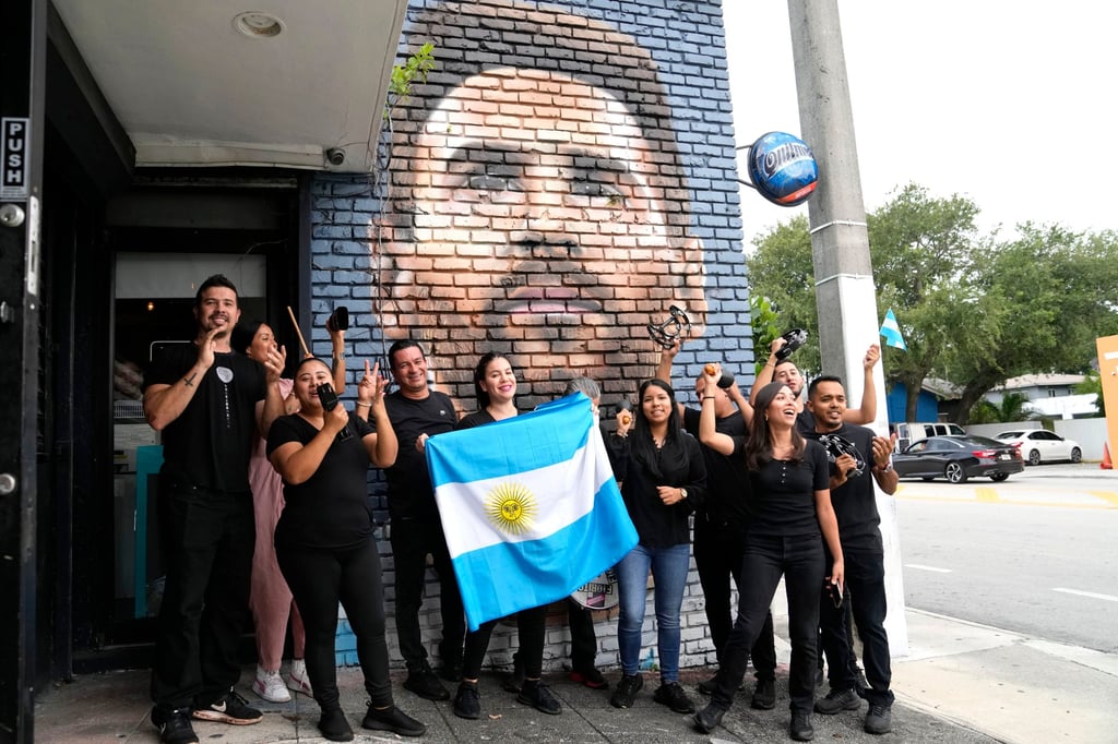 Argentines in Miami greet the news of Lionel Messi’s move in front of a mural of their country’s captain. Photo: AP