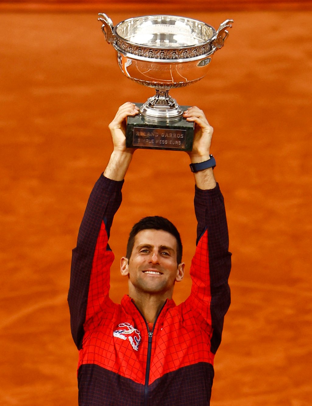 Serbia’s Novak Djokovic lifts the trophy after winning the French Open in Paris on Sunday. Photo: Reuters