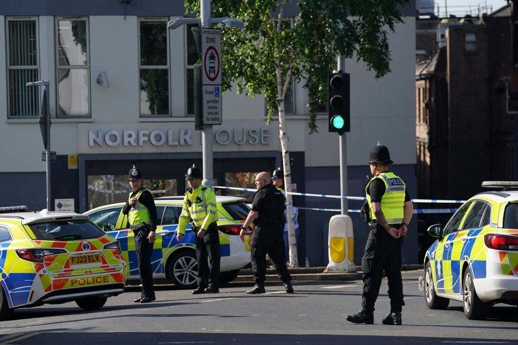 Police officers block a road in Nottingham. Photo: AP Police officers block a road in Nottingham. Photo: AP