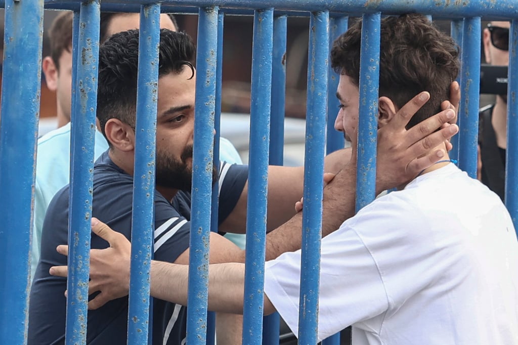 Survivor Fedi, right, reunites with his brother Mohammad, who came from Italy to meet him at the port of Kalamata, Greece. Photo: AP Survivor Fedi, right, reunites with his brother Mohammad, who came from Italy to meet him at the port of Kalamata, Greece. Photo: AP