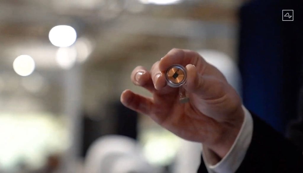 This video grab made from the online Neuralink live stream on August 28, 2020, shows the start-up’s disk implant held by company co-founder Elon Musk during the online presentation. Photo: Agence France-Presse This video grab made from the online Neuralink live stream on August 28, 2020, shows the start-up’s disk implant held by company co-founder Elon Musk during the online presentation. Photo: Agence France-Presse