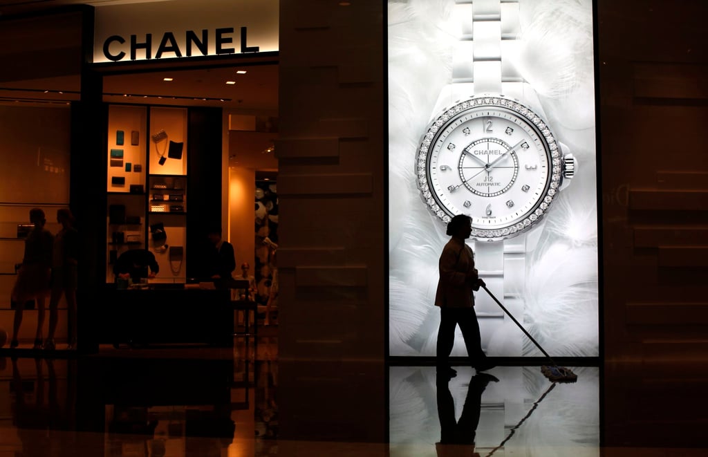 A woman cleans the floor in front of a Chanel luxury boutique at the IFC Mall in Shanghai, China. Photo: Reuters A woman cleans the floor in front of a Chanel luxury boutique at the IFC Mall in Shanghai, China. Photo: Reuters