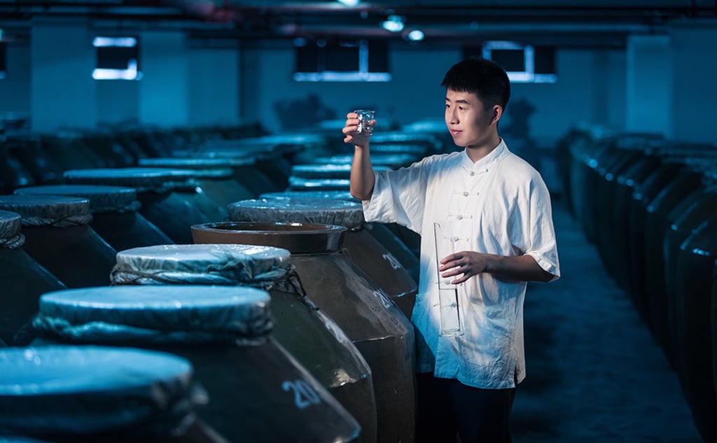 A technician checks the liquor, white wine, in the cellar of ZJLD Group, a Chinese liquor company. (Photo: ZJLD Group)