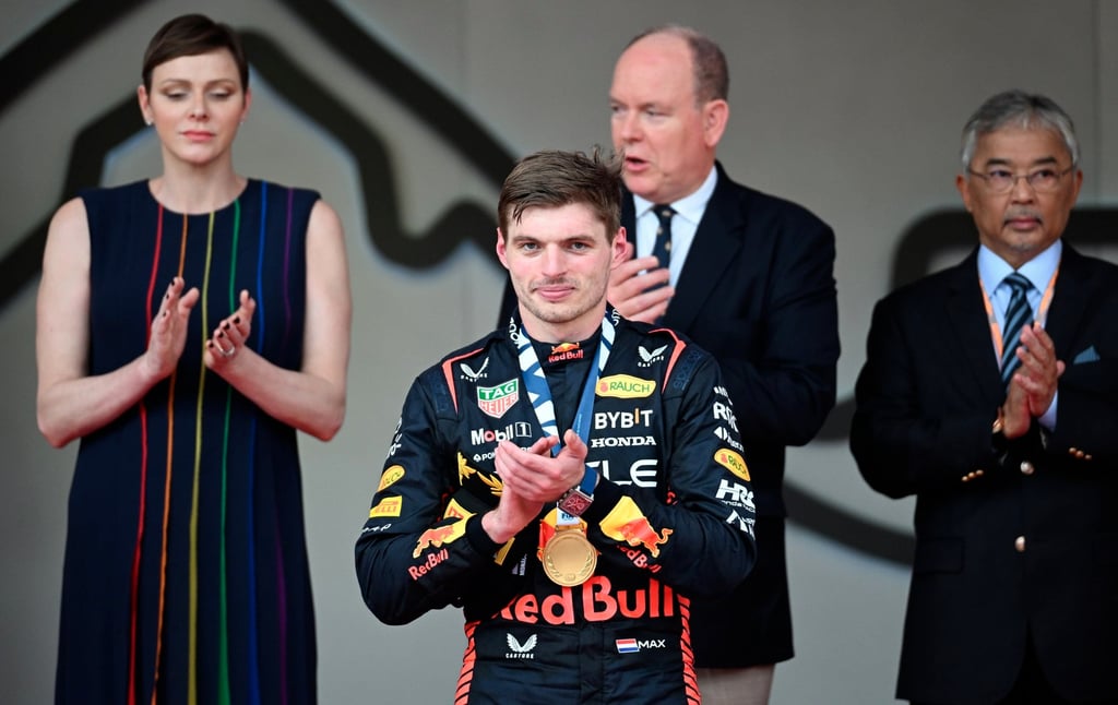 Dutch driver Max Verstappen of Red Bull Racing (centre) reacts on the podium with his medal, as Princess Charlene of Monaco (left) and Prince Albert of Monaco (centre right) applaud during the Formula One Grand Prix in Monte Carlo, Monaco, on May 28. Photo: EPA-EFE