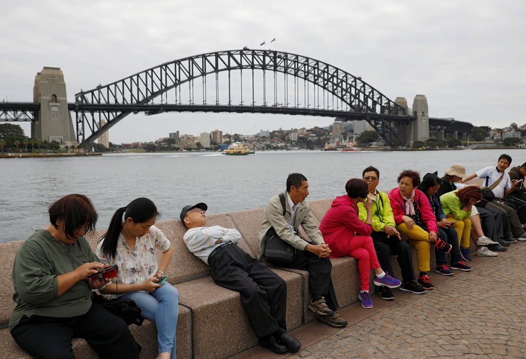 Chinese tourists rest near Sydney Harbour Bridge. Friendlier diplomacy by the government of Australian Prime Minister Anthony Albanese has cooled tensions between Beijing and Canberra. Photo: Reuters Chinese tourists rest near Sydney Harbour Bridge. Friendlier diplomacy by the government of Australian Prime Minister Anthony Albanese has cooled tensions between Beijing and Canberra. Photo: Reuters