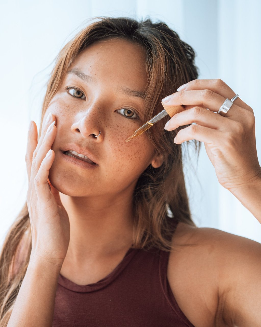 A woman applying moringa oil, which has been known to calm and soothe skin inflammations thanks to its antiseptic properties. Photo: Handout
