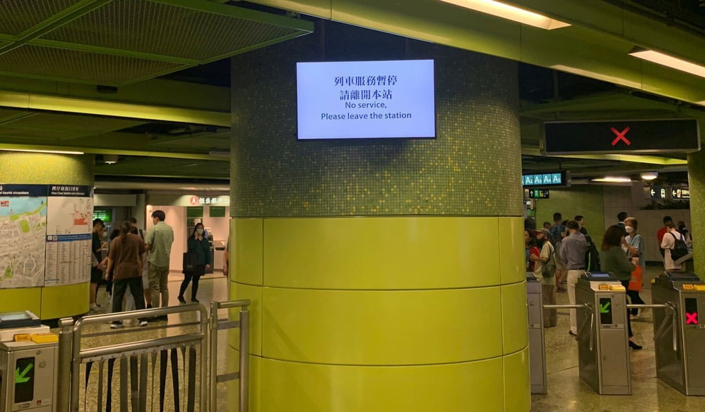 A sign displayed at the Wan Chai MTR station says services are suspended after a train arriving at the station failed to open its doors and about 20 passengers left their carriage through an emergency exit. Photo: Anna Verghese