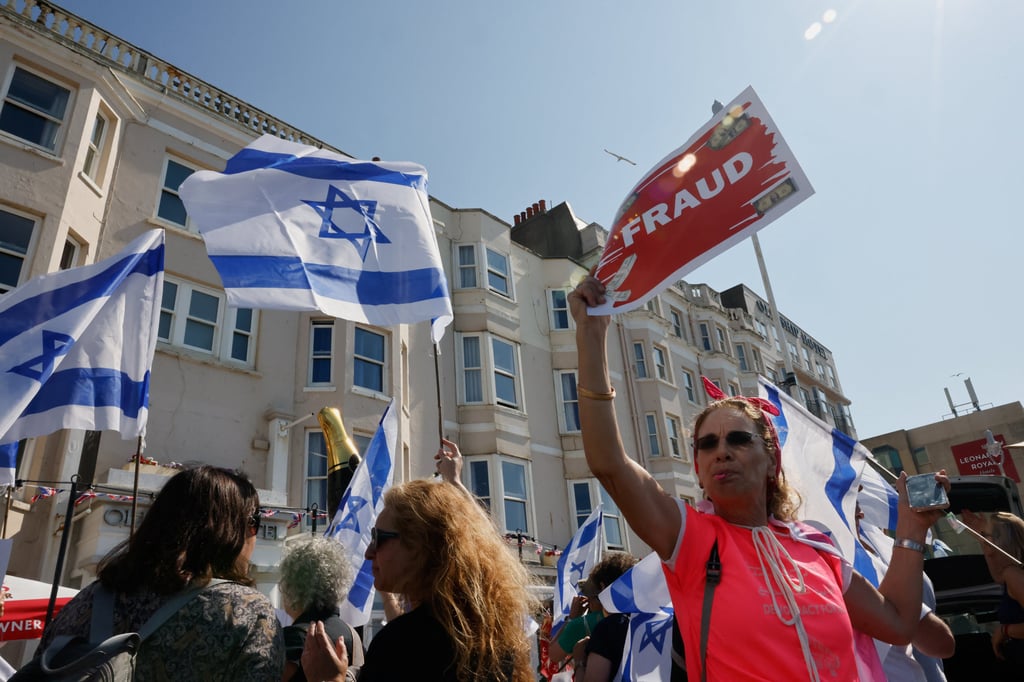 Demonstrators protest in England’s Brighton on Sunday, the day Arnon Milchan, a Hollywood producer and Israeli citizen, is expected to provide testimony via video link from the city in the trial of Israeli Prime Minister Benjamin Netanyahu. Photo: Reuters