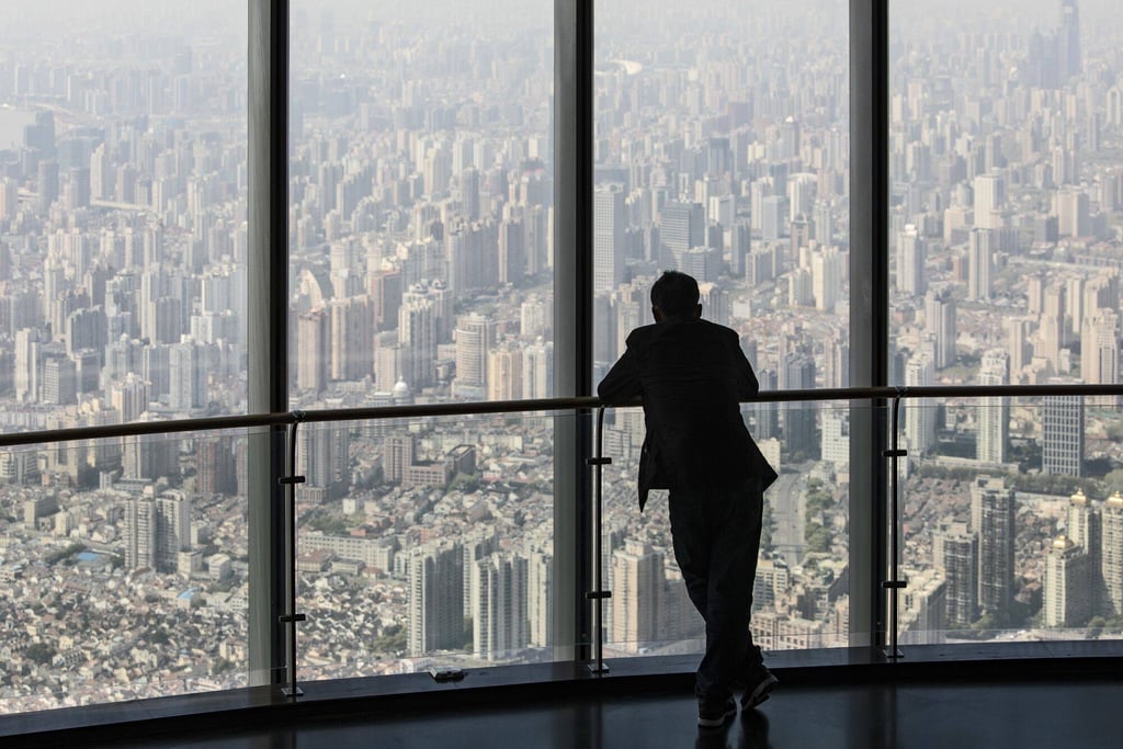A visitor takes in the view from the observation deck at Shanghai Tower in Shanghai on April 9, 2023. Photo: Bloomberg A visitor takes in the view from the observation deck at Shanghai Tower in Shanghai on April 9, 2023. Photo: Bloomberg