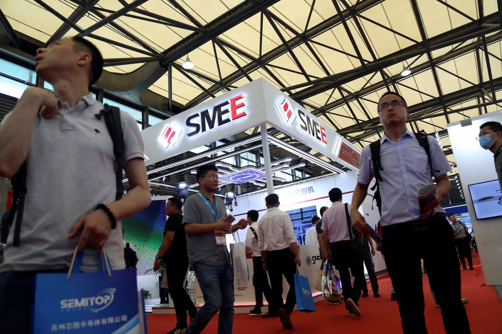 Visitors walk past the Shanghai Micro Electronics Equipment booth at the opening of the trade show Semicon China, the world’s largest semiconductor exhibition and conference, in Shanghai on June 29, 2023. Photo: Reuters