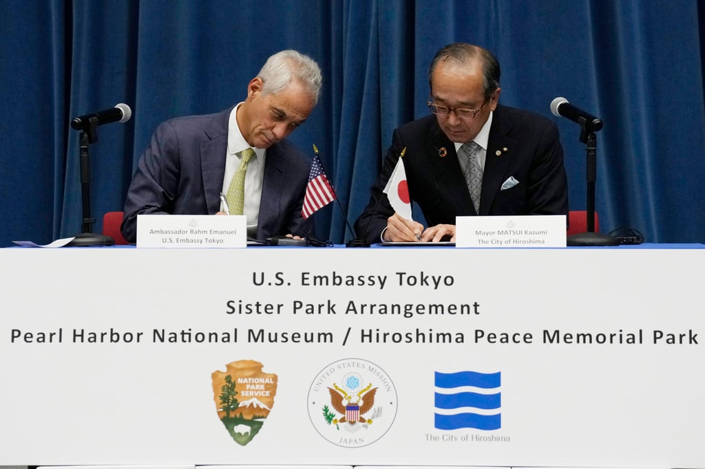 US Ambassador to Japan Rahm Emanuel and Hiroshima Mayor Kazumi Matsui sign a sister park arrangement between the Pearl Harbour National Memorial and the Hiroshima Peace Memorial Park, at the US embassy in Tokyo. Photo: AP US Ambassador to Japan Rahm Emanuel and Hiroshima Mayor Kazumi Matsui sign a sister park arrangement between the Pearl Harbour National Memorial and the Hiroshima Peace Memorial Park, at the US embassy in Tokyo. Photo: AP