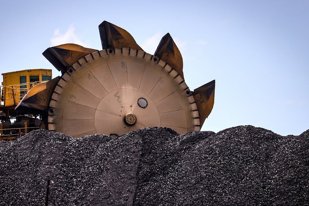 An excavator on a pile of coal at the Port of Newcastle, Australia. Photo: Bloomberg