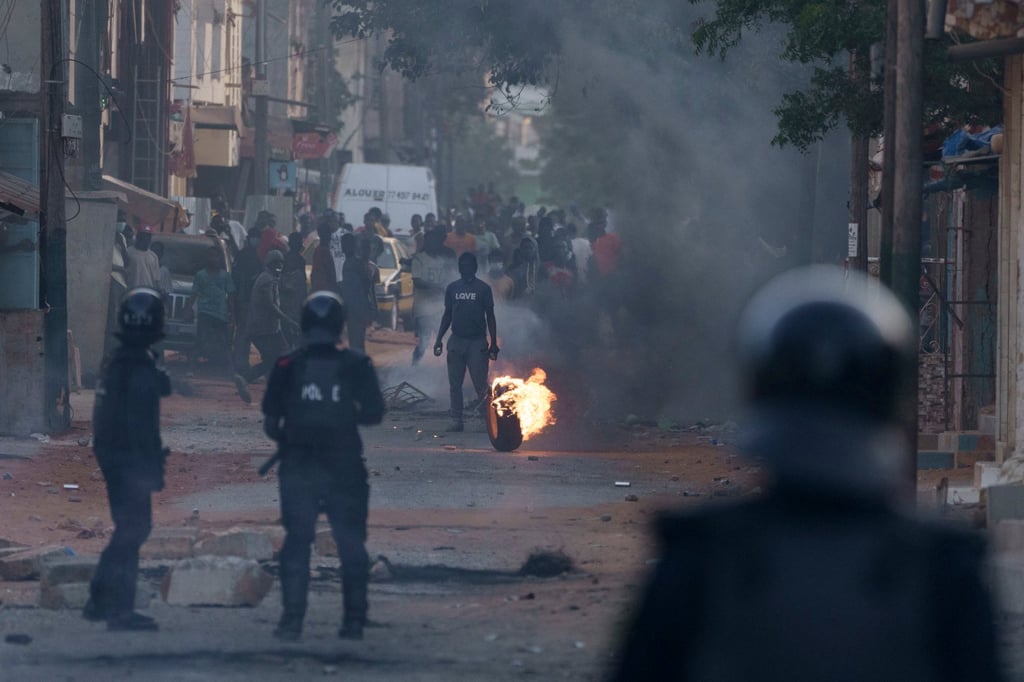 A demonstrator stand in the middle of a street during clashes with riot policemen at a neighbourhood in Dakar, Senegal on Saturday. Photo: AP A demonstrator stand in the middle of a street during clashes with riot policemen at a neighbourhood in Dakar, Senegal on Saturday. Photo: AP